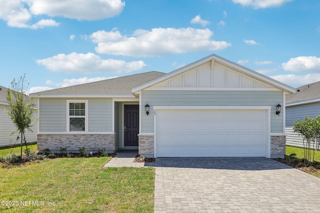 25 Ararat Dr, Palm Coast, FL 32137 - single story home featuring a front lawn, an attached garage, board and batten siding, decorative driveway, and stone siding