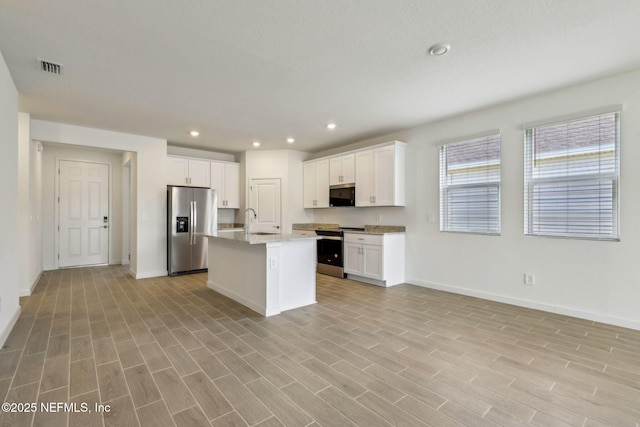 25 Ararat Dr, Palm Coast, FL 32137 - kitchen with a sink, baseboards, appliances with stainless steel finishes, open floor plan, and white cabinetry