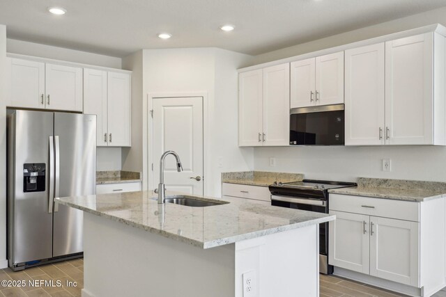 25 Ararat Dr, Palm Coast, FL 32137 - kitchen with wood tiled floor, white cabinetry, stainless steel appliances, and a sink