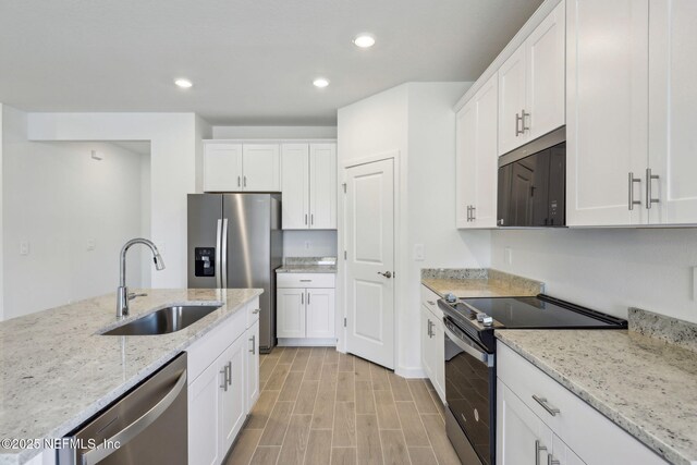 25 Ararat Dr, Palm Coast, FL 32137 - kitchen featuring white cabinets, appliances with stainless steel finishes, a sink, and recessed lighting