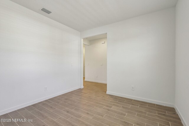 25 Ararat Dr, Palm Coast, FL 32137 - empty room featuring baseboards, wood finished floors, and visible vents