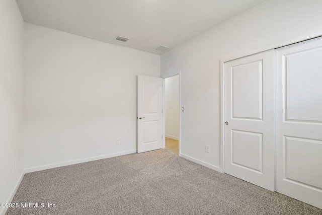 25 Ararat Dr, Palm Coast, FL 32137 - unfurnished bedroom featuring light carpet, baseboards, visible vents, and a closet