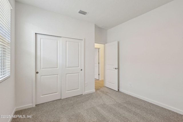 25 Ararat Dr, Palm Coast, FL 32137 - unfurnished bedroom with baseboards, visible vents, carpet floors, and a closet