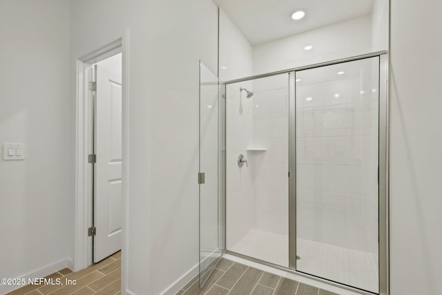 25 Ararat Dr, Palm Coast, FL 32137 - bathroom featuring wood tiled floor, a shower stall, and baseboards