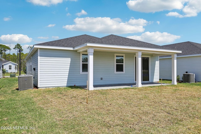 25 Ararat Dr, Palm Coast, FL 32137 - back of house with a lawn, a shingled roof, and central AC unit