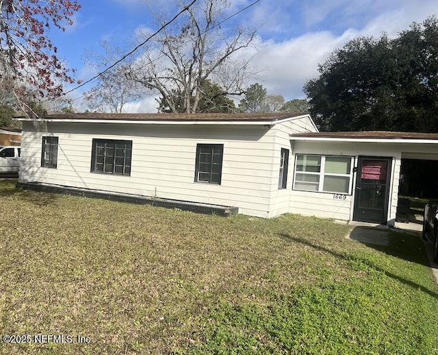 view of side of property with a lawn