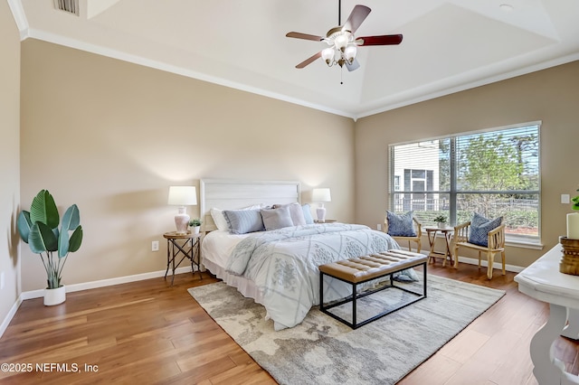 bedroom with hardwood / wood-style flooring, ceiling fan, and crown molding