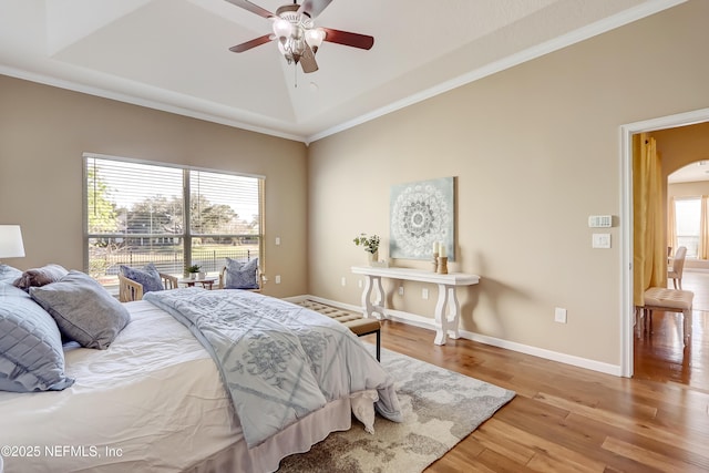 bedroom featuring wood-type flooring, ornamental molding, and ceiling fan