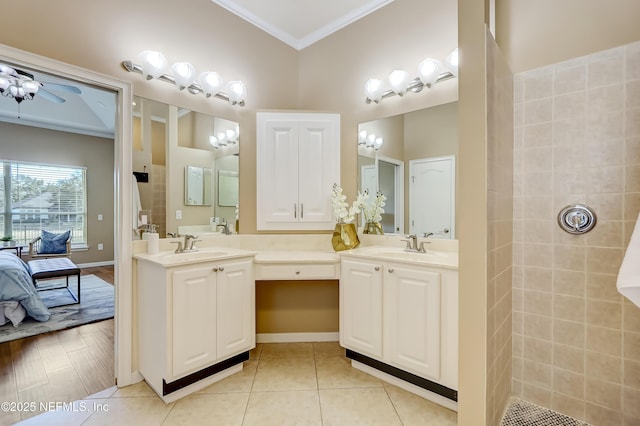 bathroom featuring ceiling fan, tile patterned floors, ornamental molding, and vanity