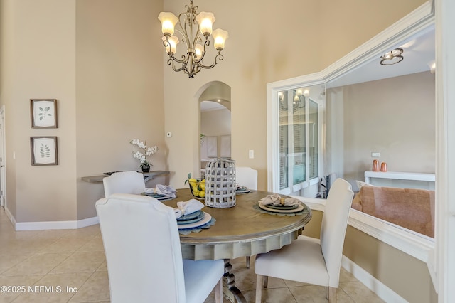 tiled dining area featuring a notable chandelier