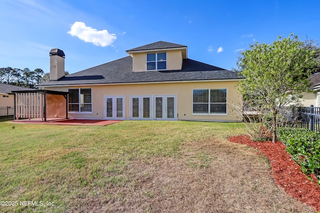 back of house featuring a lawn, french doors, and a patio area