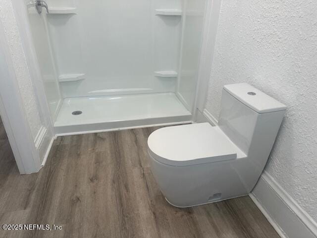 939 Jasmine Pl, Jacksonville, FL 32205 - bathroom featuring a shower, hardwood / wood-style floors, and toilet