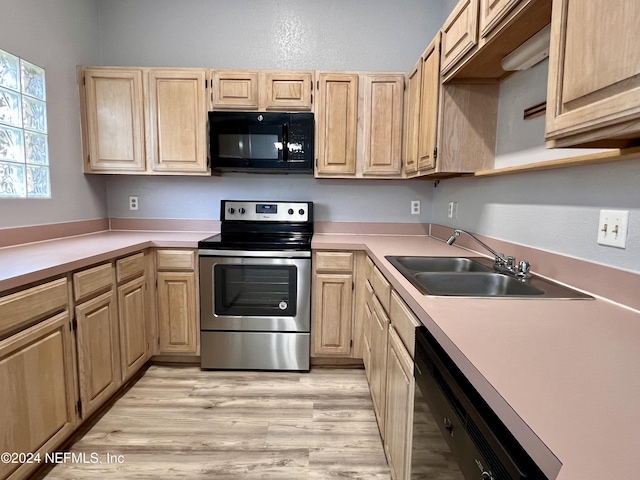 kitchen featuring light hardwood / wood-style floors, light brown cabinetry, sink, and black appliances