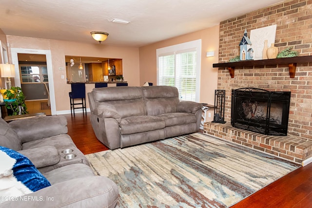 living room with hardwood / wood-style flooring and a fireplace