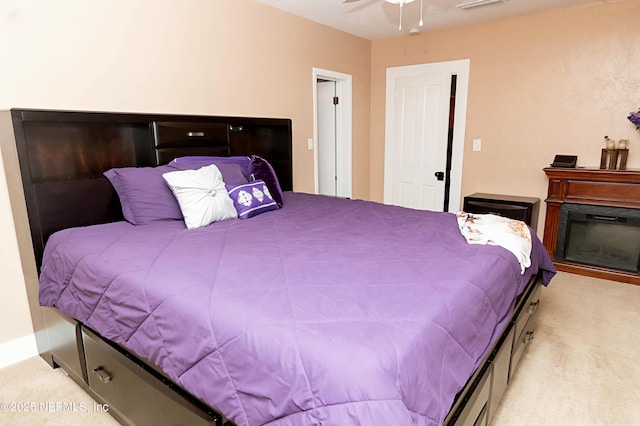 bedroom with ceiling fan and light carpet