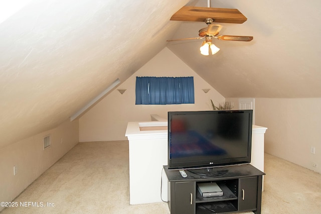 additional living space with lofted ceiling, light colored carpet, and ceiling fan