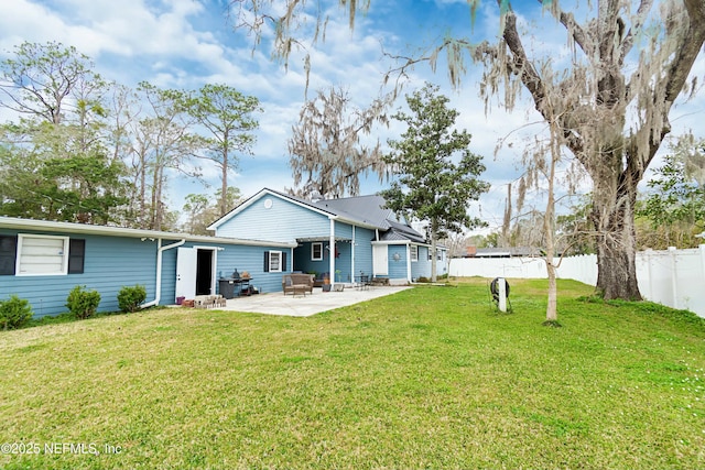 back of house featuring a yard and a patio