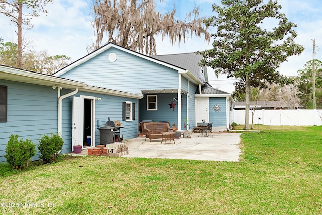 rear view of house with a patio area and a lawn