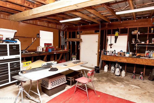 miscellaneous room featuring concrete flooring and a workshop area