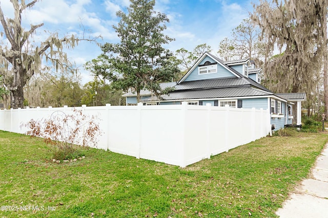 view of side of home with a lawn