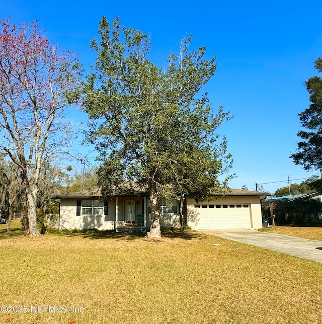 view of front of property with a garage and a front lawn