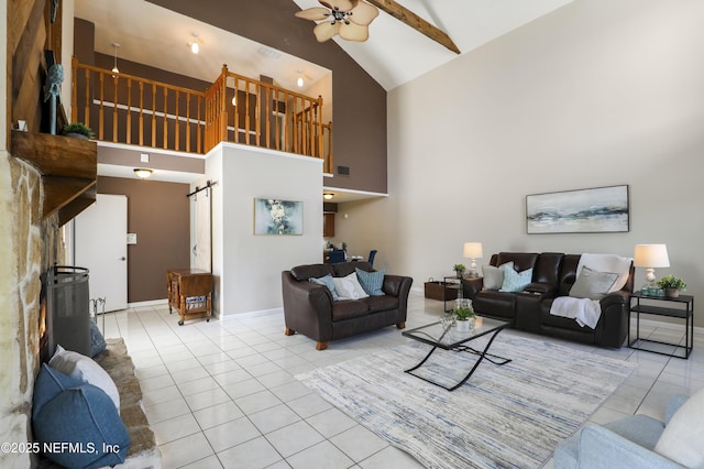 tiled living area featuring a barn door, baseboards, visible vents, a ceiling fan, and high vaulted ceiling