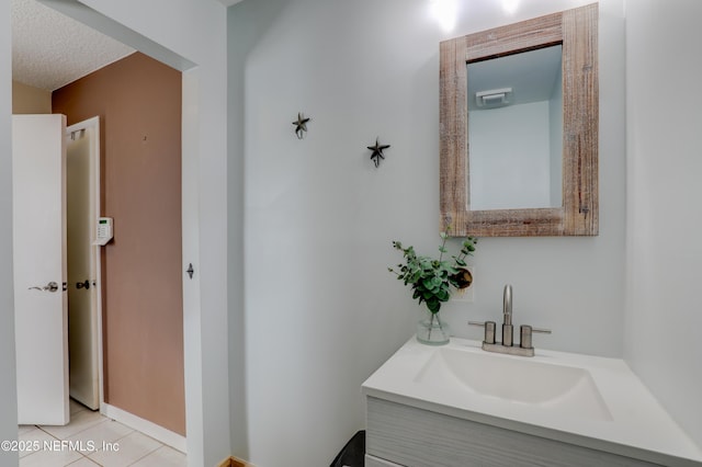 bathroom with tile patterned floors, a textured ceiling, and vanity