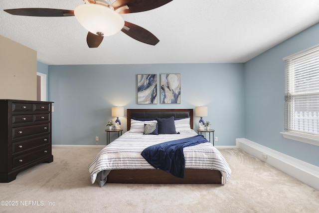 bedroom with carpet flooring, ceiling fan, a textured ceiling, and baseboards