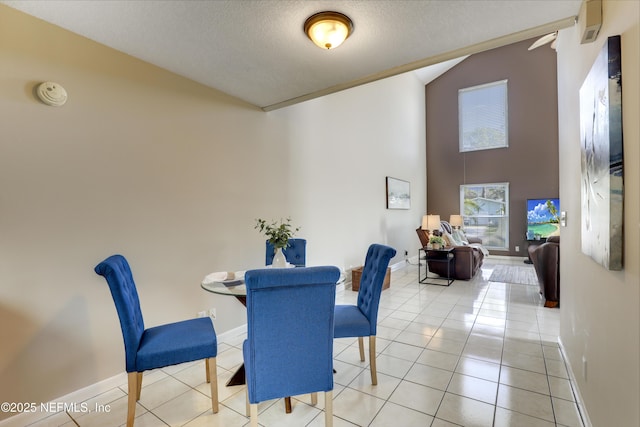 dining room featuring high vaulted ceiling, baseboards, a textured ceiling, and light tile patterned flooring