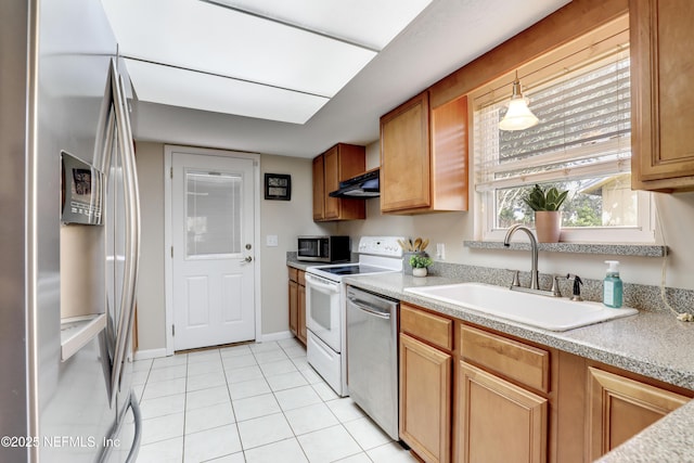 kitchen featuring light tile patterned floors, stainless steel appliances, light countertops, a sink, and under cabinet range hood