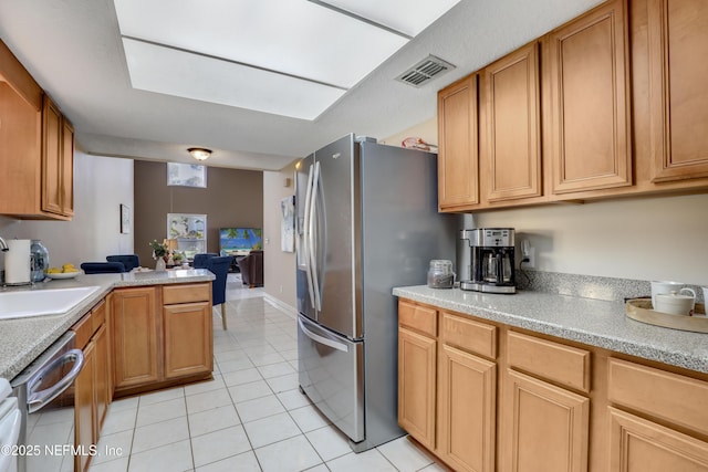 kitchen with light tile patterned floors, a sink, visible vents, light countertops, and appliances with stainless steel finishes