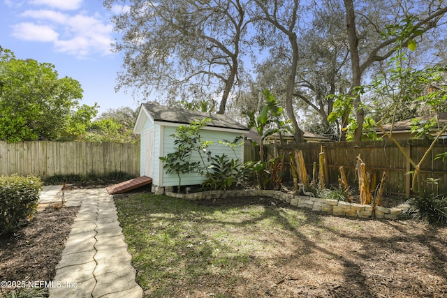 view of yard featuring a fenced backyard, a storage unit, and an outdoor structure