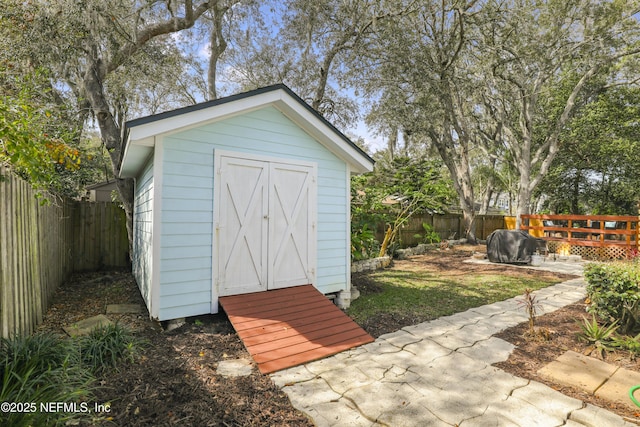 view of shed with a fenced backyard