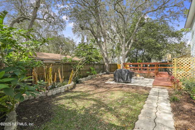 view of yard with a fenced backyard and a wooden deck