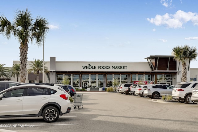 view of property featuring uncovered parking