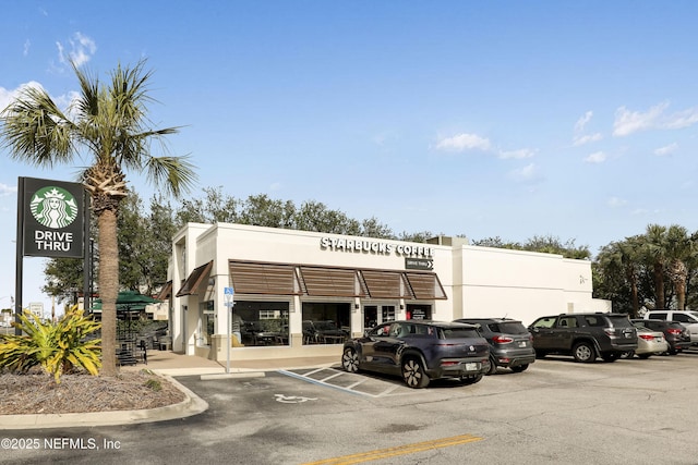 view of property featuring uncovered parking