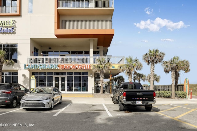 view of building exterior featuring uncovered parking