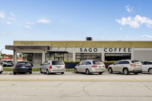 view of building exterior featuring uncovered parking