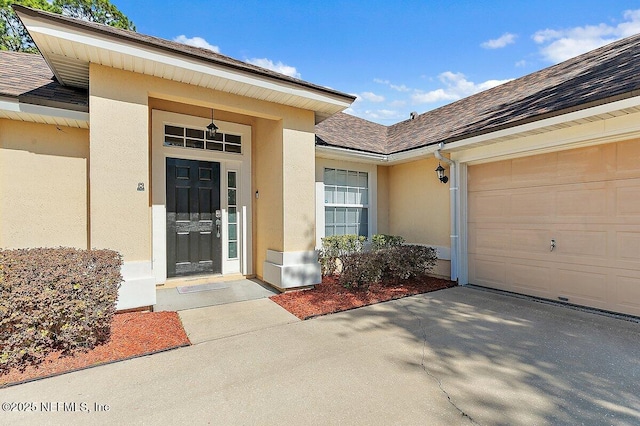 doorway to property with a garage