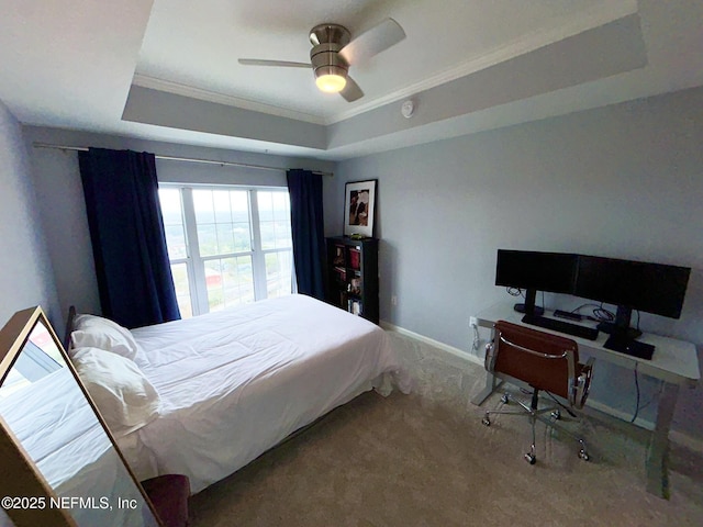 bedroom featuring a raised ceiling, crown molding, carpet floors, and ceiling fan