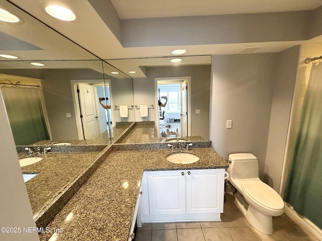 bathroom with vanity, tile patterned floors, and toilet