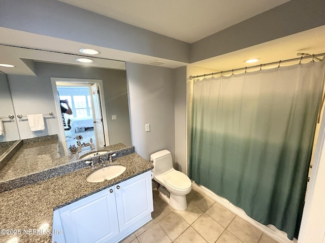 bathroom with tile patterned floors, vanity, and toilet