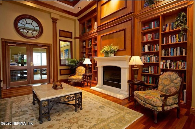 living area with hardwood / wood-style flooring and built in features