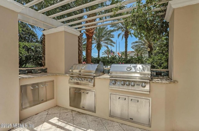 view of patio / terrace featuring area for grilling, a pergola, and grilling area
