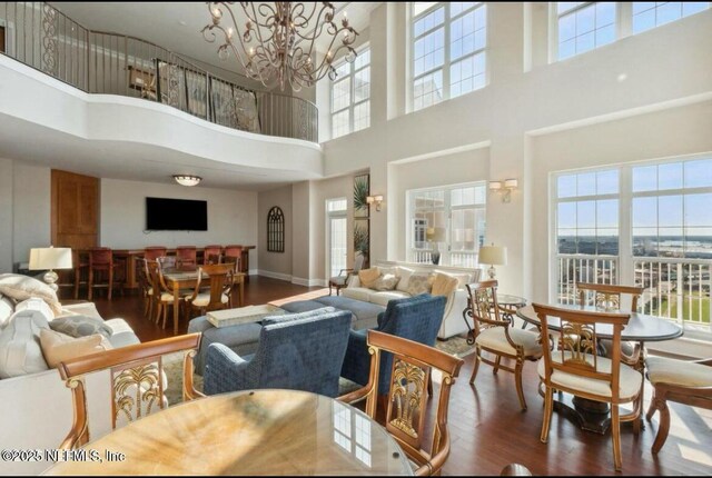 living room with dark wood-type flooring and a chandelier