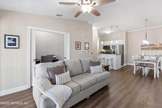 living room featuring ceiling fan and dark hardwood / wood-style flooring