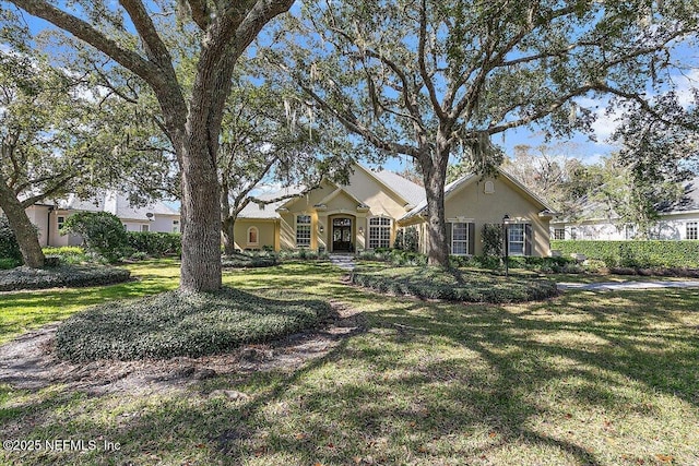 ranch-style home featuring a front lawn