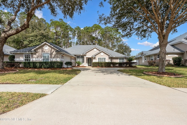 single story home with a garage and a front lawn