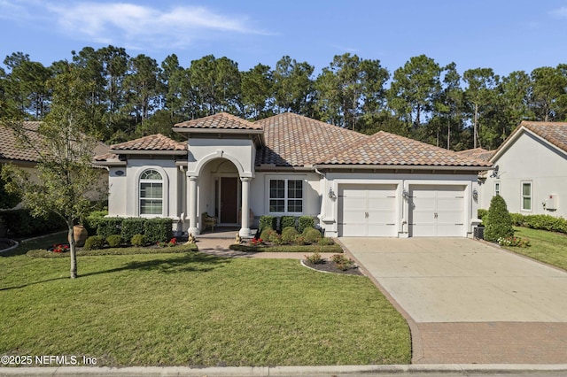 mediterranean / spanish-style house with a garage and a front yard