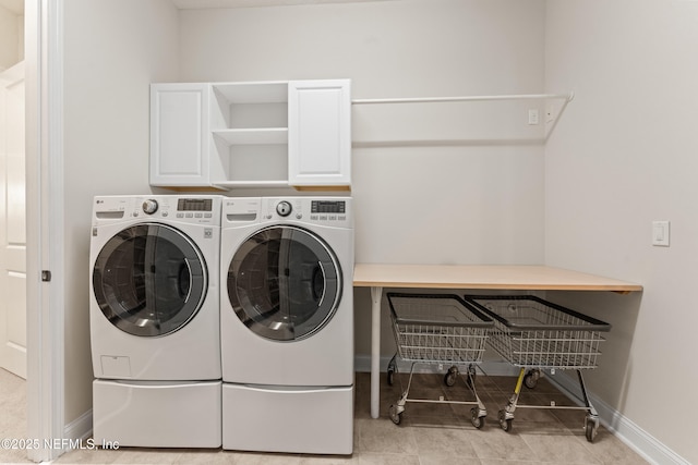 washroom with cabinets and separate washer and dryer